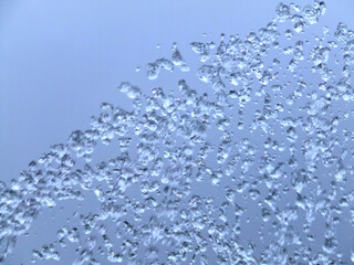 Water drops and splash in cloudy sky