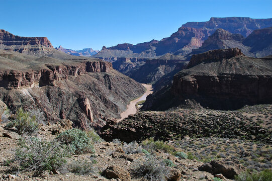 Landscape of Grand Canyon from Tonto plateau level with Colorado River running down the center of image