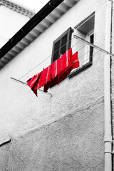 Washing line in front of a window in Antibes, France.    Black and white, with only the cloth in...