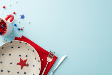 Fototapeta Captivating top view of table set for celebrating Independence Day, adorned with patriotic accessories: plate, cutlery, napkin, sprinkles in mug, stars. Pastel blue backdrop with empty space for text obraz