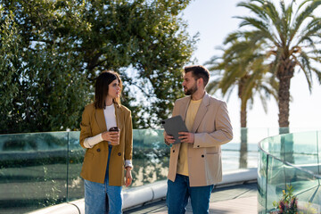 Two serious business professionals man and woman team partners discussing business strategy plan on...