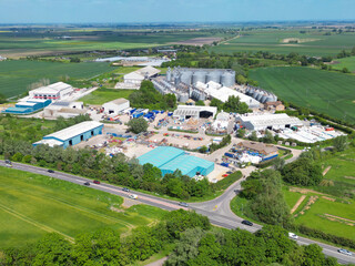 Aerial view of a large industrial estate seen in a rural location in East Anglia. Large grain silos can be seen in the distance.