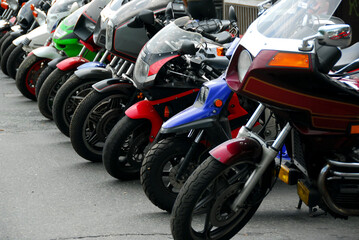 Fototapeta na wymiar Row of motocycles parked on a street in front a motorcycle store