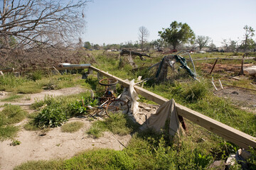 Heavily damaged homes in the Ninth Ward of New Orleans. One block behind these homes is the...