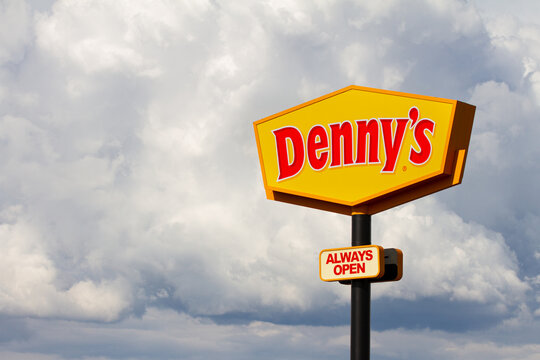 BOISE, IDAHO - MAY 29, 2019 - Dennys restaurant sign with a backdrop of clouds near the Boise Airport