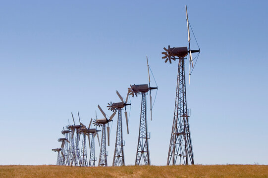 A group of windmills on rolling hills in California.