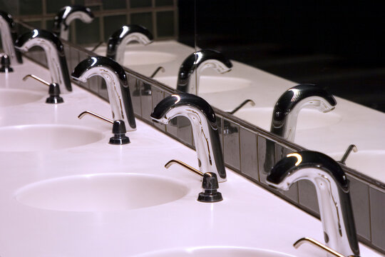 A line of sinks in a public bathroom.