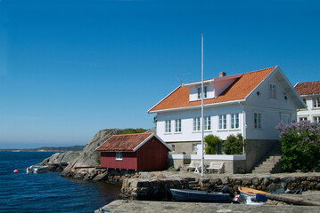 House and boathouse by the sea in Loshavn near Farsund in Vest-Agder on the south coast of Norway