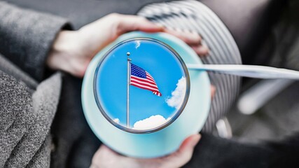 Female hands holding a cup with american flag inside. Concept ndependence Day
