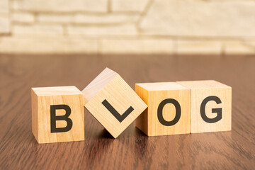 wooden blocks with word BLOG on dark wooden background. frequently asked question concept