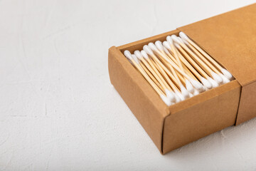 White cotton swabs on concrete texture background. Cotton buds. Bamboo cotton buds. Eco friendly. Hygienic cotton swabs for ears. Place for text. Place to copy.