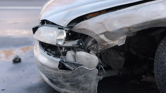 Damaged automobile, tape barrier, crashed auto. Vehicle, its front-end wrecked in crash, enclosed by emergency tape.