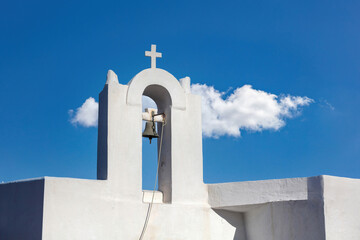 Small church belfry, white color chapel roof on clear blue sky background