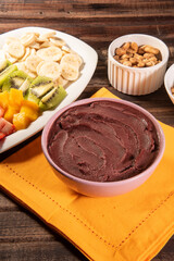 Brazilian açaí in a bowl accompanied by tropical fruits. Fruit of the Amazon