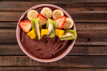 Brazilian açaí in a bowl accompanied by tropical fruits. Fruit of the Amazon