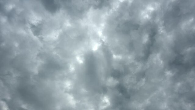 Mixed white to gray storm clouds moving in a time lapse from bottom right toward top left. The occasional patches of blue sky appear.

