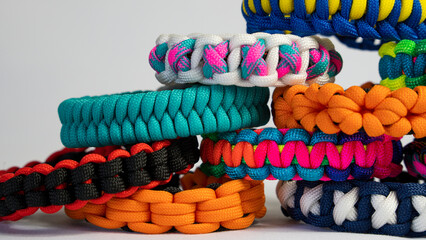 Fototapeta na wymiar Lots of braided paracord bracelets