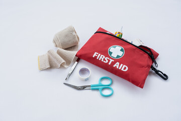 First aid medical kit and supplies on white background, copy space
