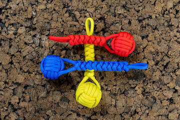Braided paracord keychains on a cork background. Handmade, creative design.