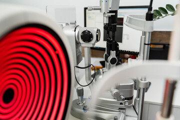 Corneal topographer shines red light and slit lamp for topography examination. Corneal topography...