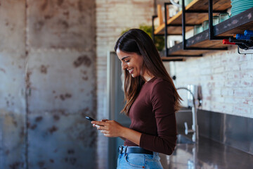 Side profile of young woman using mobile phone.