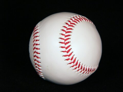A baseball on a black background
