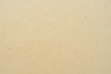 Smooth mustard or beige background, warm tones, texture of old paper or wallpaper with some stains and small tears.