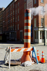 Steam venting from the street, utility pipe hot steam to building for heating, south street sea...