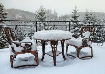 Table and chairs on a winter terrace - 609166603
