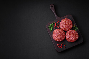 Fresh raw ground beef burger patty with salt and spices