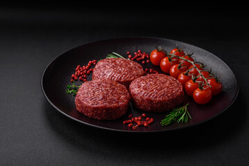 Fresh raw ground beef burger patty with salt and spices