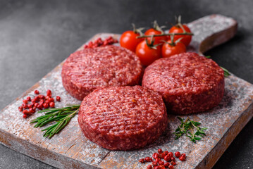 Fresh raw ground beef burger patty with salt and spices