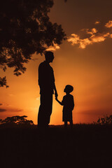 Fototapeta na wymiar Father and son silhouette at sunset