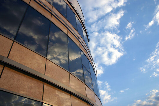 Corporate building and the sky. Reflections of the clouds on the windows