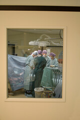 Docters/surgeons/mediacal personel at work in a surgeryroom - obrazy, fototapety, plakaty