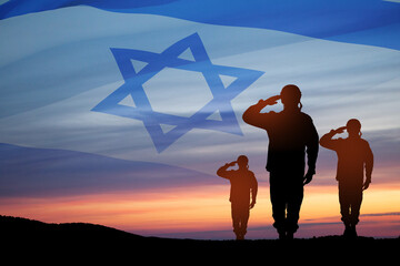 Silhouette of soldiers saluting against the sunrise in the desert and Israel flag.