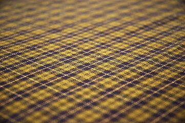 checkered celtic fabric textured background. shallow DOF.