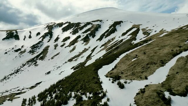 A view of the snow-covered eaves and couloirs of Hoverla from the height of a drone, the Carpathians