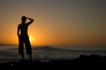 Fototapeta premium Girl looks out to the future at La Santa beach in Lanzarote