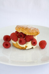 Butter Milk Biscut overflowing with fresh raspberries and cream