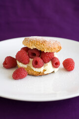 Butter Milk Biscut overflowing with fresh raspberries and cream