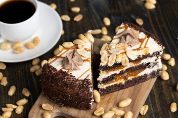 a piece of chocolate cake with caramel and peanuts