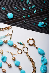 author collection jewelry with azure gemstones, pearls and chain demonstrated at white and black...