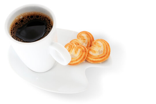 White coffee cup with heart=shaped biscuits over white background