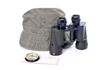 Hat, compass and binoculars on a white background
