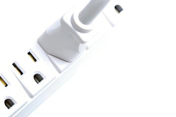 plug, plugged into a multiple outlet. highkey macro over white.