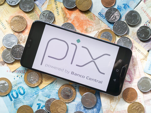 Bahia, Brazil, 02 june 2023. Pix application on the smartphone screen on coins and banknotes of Brazilian money