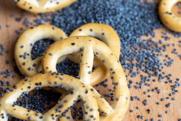 Poppy seed coating dried bagels on the table