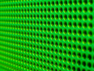 Futuristic green hole grid making an abstract pattern.