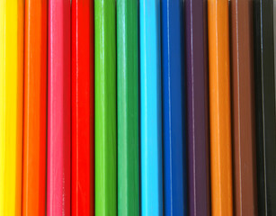 Wooden colour pencils close-up background.